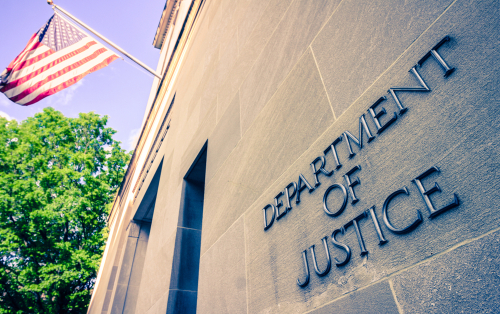 Department of Justice building with American flag.