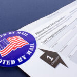 Mail-in ballot application with "I Voted By Mail" sticker.