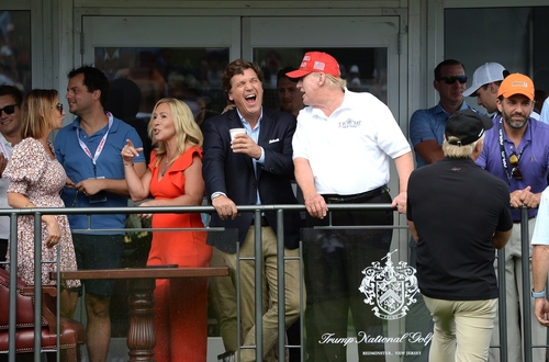 Group of people at Trump National Golf Course event.