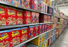 Cereal aisle with Fruity Pebbles and other cereal boxes.