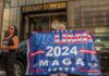 People holding Trump 2024 MAGA banner outside Trump Tower.