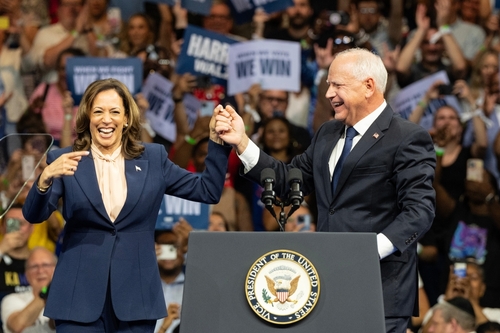 Kamala Harris and Tim Walz celebrate onstage.