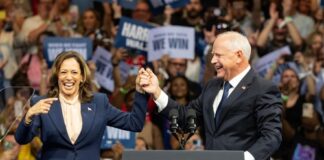 Kamala Harris and Tim Walz celebrate onstage.