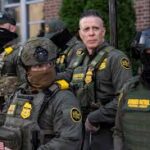 A group of law enforcement officers in tactical gear standing together