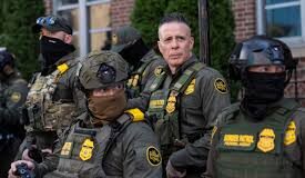 A group of law enforcement officers in tactical gear standing together