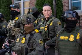 images (29).jpg A group of law enforcement officers in tactical gear standing together