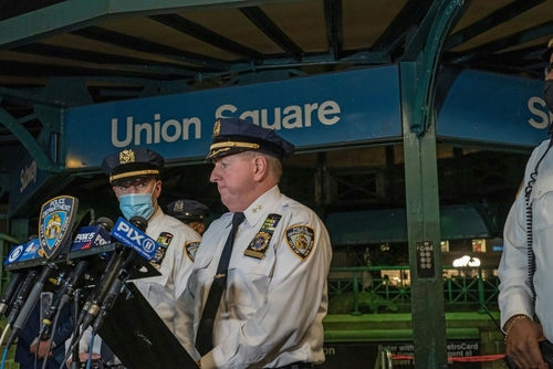 shutterstock_2063810501 (2).jpg NYPD officers speak at Union Square station podium.