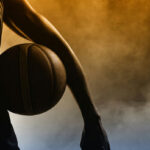 Basketball player silhouette with a ball in hand.