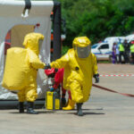 Chemical Implosion HORROR – Fatal Disaster Unfolds…. Hazmat-suited workers exit a decontamination tent