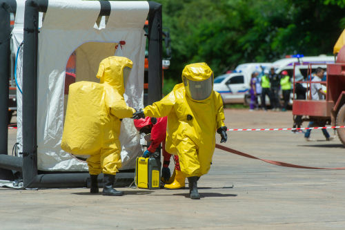 shutterstock1127681561jpg Hazmat-suited workers exit a decontamination tent