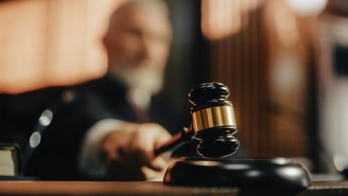 shutterstock2056414424-2jpg Judge striking gavel in courtroom.
