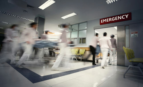 shutterstock_1675290874 Medical staff rushing patient on stretcher in emergency room.