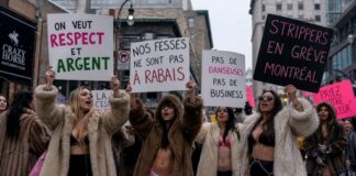 Group of women in fur coats holding protest signs in Montreal