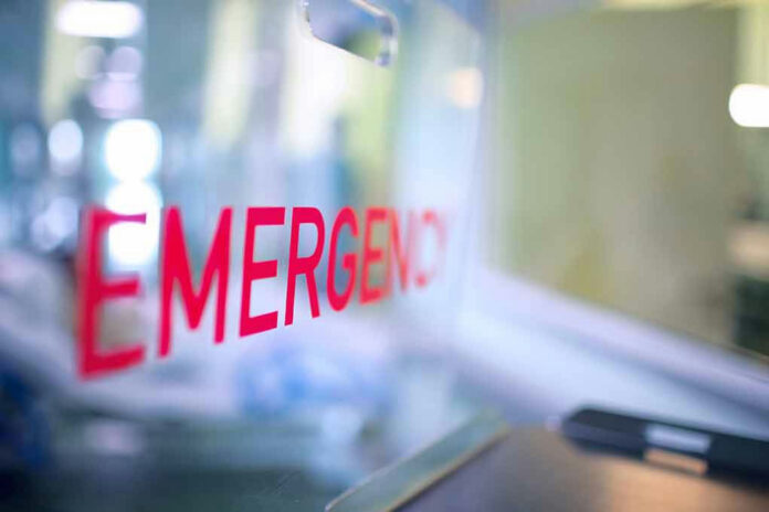 1879006621 Red EMERGENCY sign on glass door.