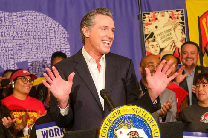 2368126835 Man speaking at podium with smiling audience behind.