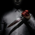 Neck Stabbing Sparks Alarm — Police Yet to Explain Why Person holding bloody knife in dark lighting.