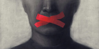 Portrait of a person with red tape crossing their mouth