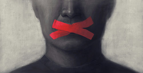 shutterstock1851762079jpg-1 Portrait of a person with red tape crossing their mouth