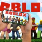 63,000 Letters Rattle Putin’s Gate Hands holding a smartphone displaying the Roblox game with characters in the background
