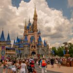 Fifty-Foot Fall—Shocking Disneyland Scare Crowd of visitors in front of a large Disney castle under a cloudy sky