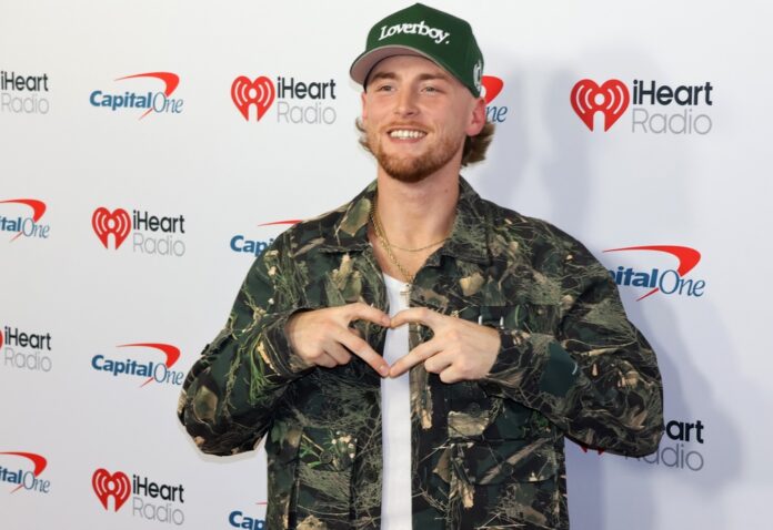 Bailey,Zimmerman,At,The,2025,Iheartradio,Music,Festival,Held,At View through an ornate archway leading to a tropical entrance with palm trees and parked cars