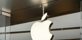 Illuminated Apple logo inside a store.
