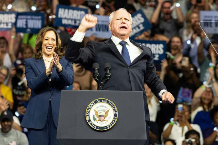 2499464703 Two people at a political rally on stage.