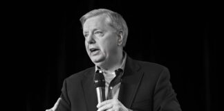 Man speaking into a microphone on stage