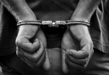 hands in handcuffs behind back