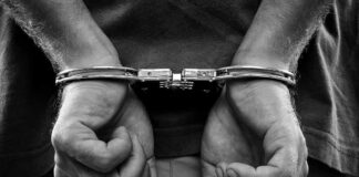 hands in handcuffs behind back