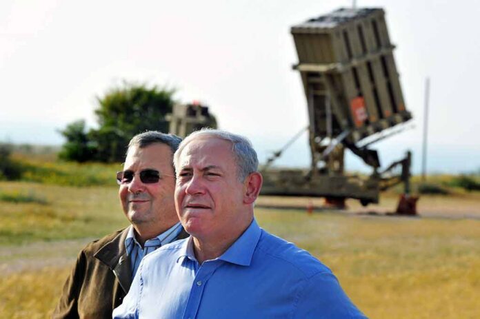 two men standing near a missile defense launcher outdoors
