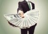 Harassment Payout — President Still Cashes In Businessperson holding a fan of US dollar bills