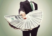 Businessperson holding a fan of US dollar bills
