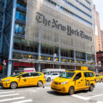 NYT Bombshell Backfires — What Got Buried? Busy street scene in New York City with yellow taxis and The New York Times building