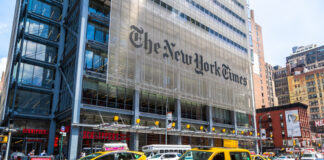 Busy street scene in New York City with yellow taxis and The New York Times building