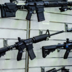 Hypocrisy Exposed: ‘Gun-Free’ Campuses Stockpile AR-15s Two armed police officers engaging with a man outside.