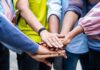 group hands stacked in a team huddle