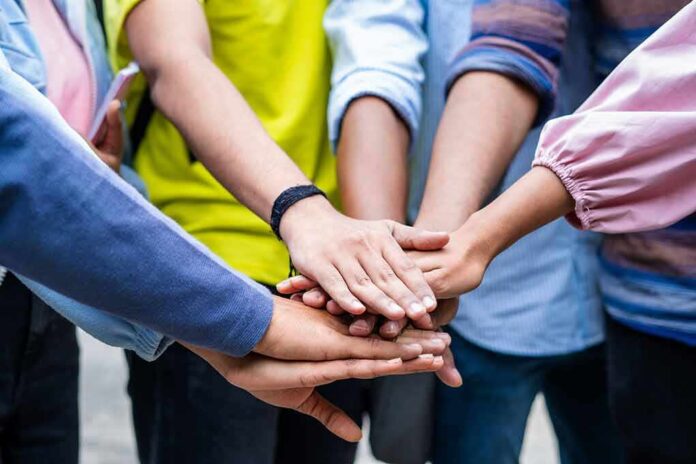 group hands stacked in a team huddle