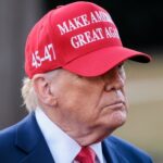 Hollywood Rebel Flips: Trump Becomes Only Choice A man wearing a red cap with a political slogan, looking serious