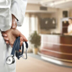 Misdiagnosis Horror Sparks $25M Jury Fury A doctor holding a stethoscope behind their back in a hospital reception area