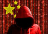 State Propaganda Targets Filipinos — Where’s The Outrage? A hooded figure in a red hoodie against a backdrop of binary code and stars representing China